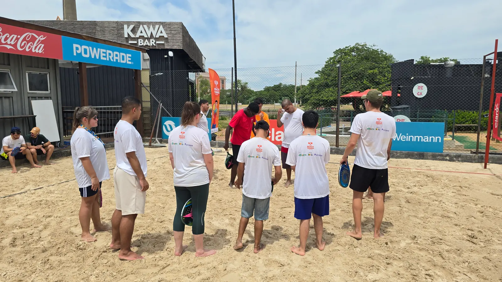Turma reunida na quadra de areia antes do início da aula.